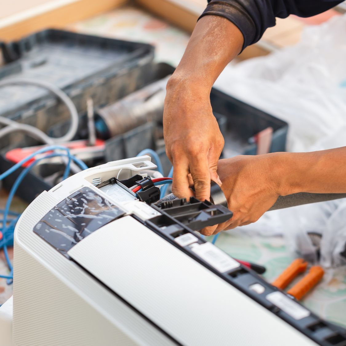 Air conditioning technician installing new air conditioner in a home Air conditioning technician installing new air conditioner in a home